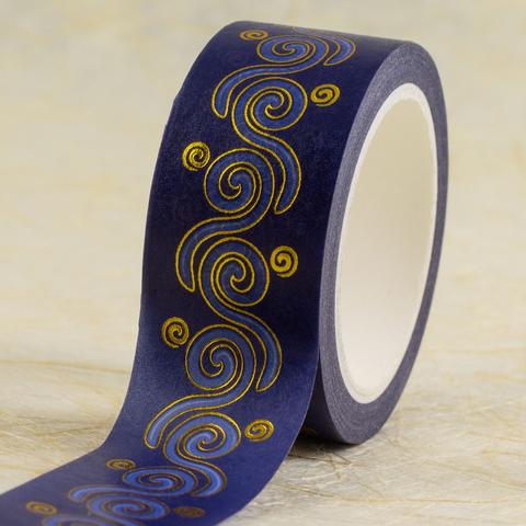 A roll of 20mm wide washi tape with a stream of spirals with alternating chirality in shades of blue with gold outlines and smaller gold spirals along the edges, partly unrolled to show the design.