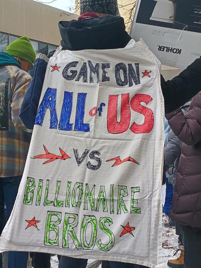 Sign that reads: Game on 
All of us 
versus 
Billionaire Bros