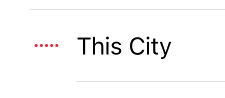 A screen capture of a music track from the iOS Music app. The track, named This City, has 5 small, red dots to the left of it. These dots are meant to animate like an audio meter when a track is playing. Though The City was, indeed, playing when taking this screenshot, there is no animation.