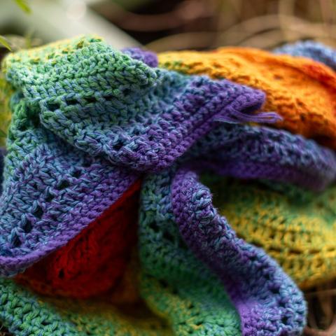 A piled up rainbow cable crocheted scarf