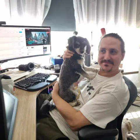 Me at my desk cuddling my cute little doggie