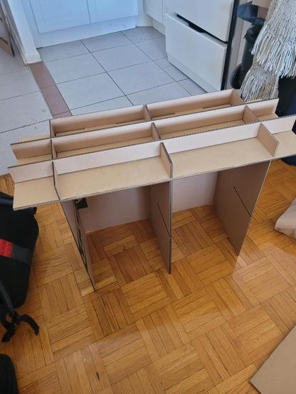 Starting assembly: shelf upside down showing support at the base