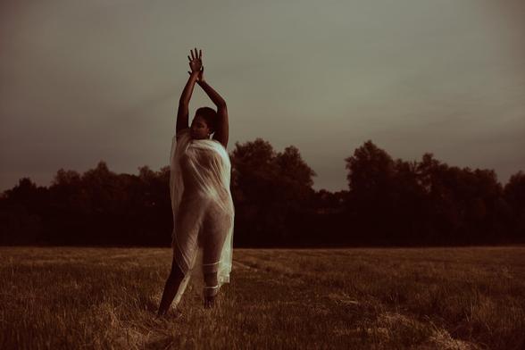 Editorial photograph of a model on an open field