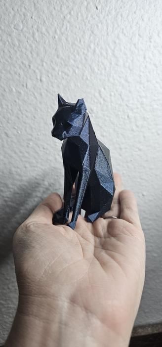 Photo of a very pretty sparkly blue 3D angled cat statue I printed