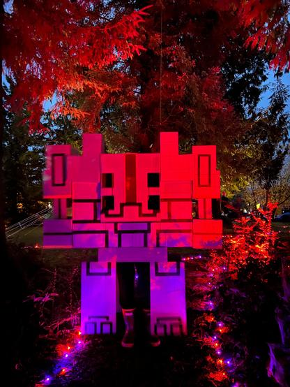 Minecraft Monstrosity cardboard and duct tape costume bathed in red and purple light.