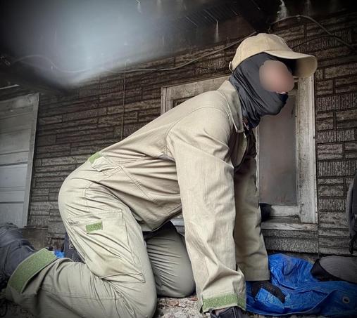 In this image, a powerful quadrupedal figure is on all fours, resembling an equine form. Dressed in a tactical-inspired ensemble, the workhorse wears a khaki/tan military-style jumpsuit with utility pockets and strategically placed green velcro patches on their legs and arms. A matching tan baseball cap adorned with a horse icon, a black neck gaiter, and a pair of black tactical
work boots complete the look, creating an intriguing blend of utilitarian and equine aesthetics.

The scene is set in the stable against a textured wooden wall background, bathed in moody lighting, which enhances the dramatic presentation. The figure’s posture perfectly captures the essence of equine movement, with their weight balanced on all fours in a controlled and purposeful stance. Blue tarps or materials can be seen in the background, adding contrast to the predominantly beige tones of the subject.

The combination of military-inspired clothing and the horse-like posture creates a unique fusion of tactical utility and animal roleplay aesthetics, showcasing a meticulous attention to both form and function in the presentation.