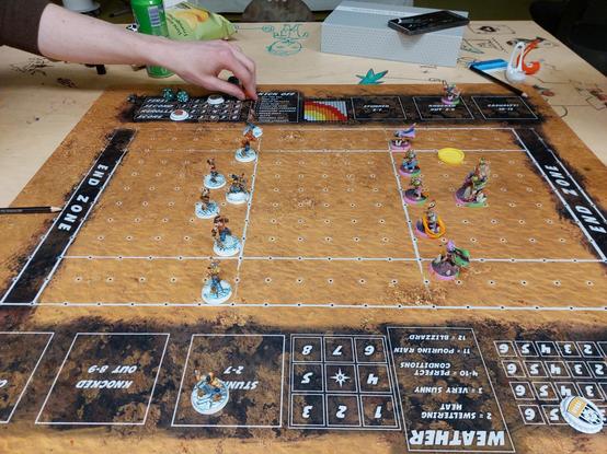 Desert themed blood bowl seventh pitch with Norse on ice and snow bases versus Skaven on neon disco bases