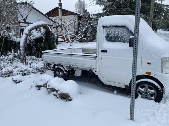 A small kei truck covered in snow. Is it tokyo? Nope! Vancouver Island.