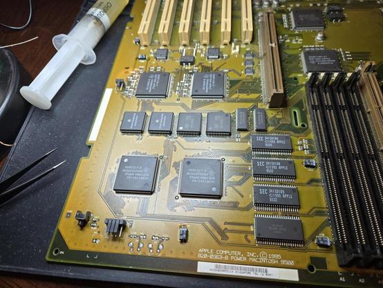 picture of a PowerMac 9500 motherboard.  some of the electrolytic caps on the left and front of the picture have been replaced with tantalum caps. the soldering is shoddy but will work.