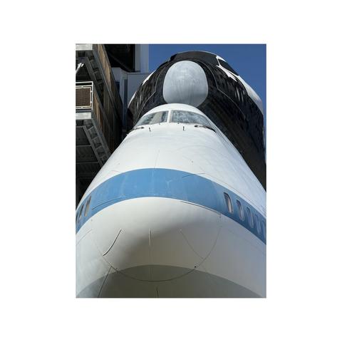 close up of noses of space shuttle above 747 transport