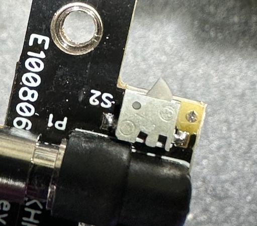 Image of part of an Elecraft KH1 paddle, partially disassembled, showing the replacement microswitch soldered in position.