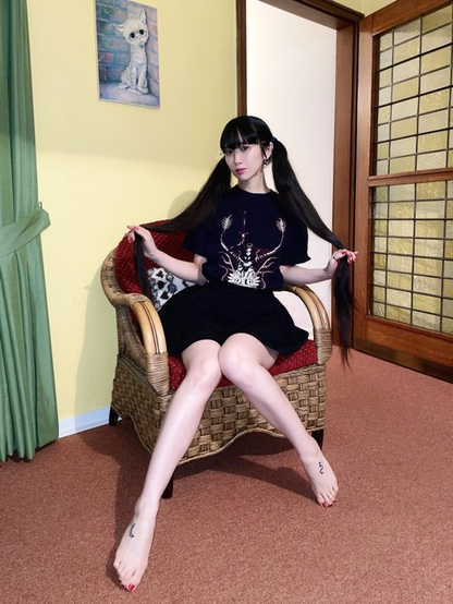 Hima in a wicker chair hold out twin-tails