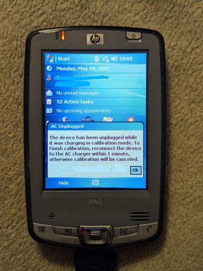 A picture of a HX 2000 series pocket PC. 

A message is on the screen that reads " The device has been unplugged while it was charging in calibration mode. To finish calibration, reconnect the device to the AC charger within 1 minute, otherwise calibration will be canceled."