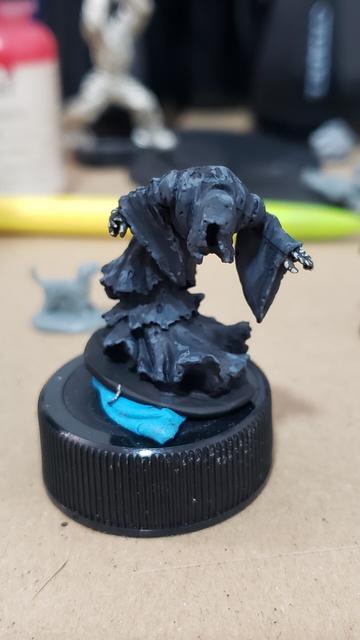 Hunched wraith miniature with blowing black robes and skeletal hands