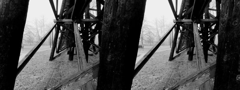 Black and white, stereoscopic, side-by-side image. A view from inside a former train trestle.