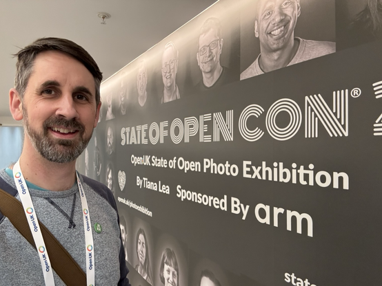 Andy in front of the conference photo wall