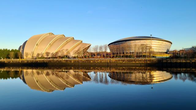 Two uniquely shaped modern buildings on the banks of the Clyde in Glasgow.