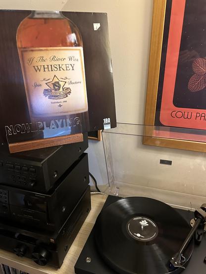 Front cover of If The River Was Whiskey by Spin Doctors next to the turntable.