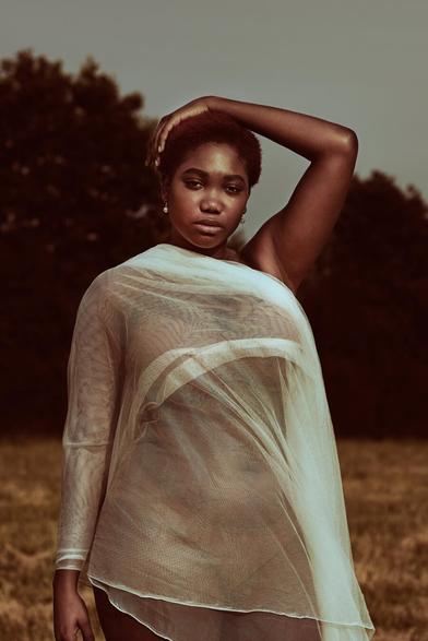 Editorial photograph of a model on an open field