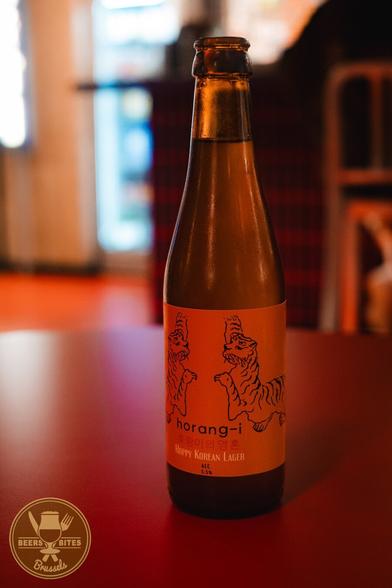 A bottle of beer labeled “Horangi.” A logo for “Beers and Bites Brussels” is visible.