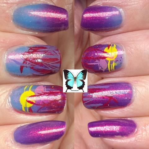 two images stitched together to show 8 finger tips they are alligned vertically with the index fingers at the top and the pinkies top the bottom, the nails are pained with a thermal polish that is a red toned purple when cold and a blue toned lavender when hot, there is a grass image stamped in the middle  and ring fingers to both hands in red and purple. This photo is showing both warm and cold states of the polish