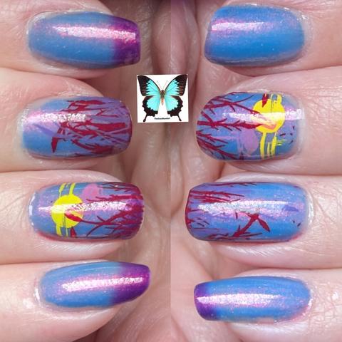 This image is showing the warm state of the polish, it makes the stamping much more visible there is a yellow sun on the middle fingers of both hands.