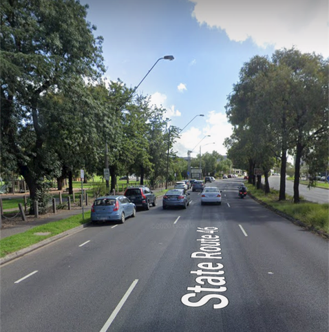 Google street view of Heidelberg Rd in February 2020.
The road is a dual carriage way with 3 lanes in each direction, on the far left is a dashed line marking the bike lane, there are two cars parked in the bike lane.