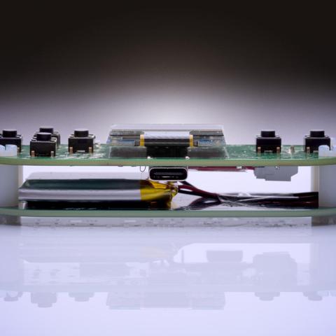 Side view of game console. Lipo battery is clearly visible.