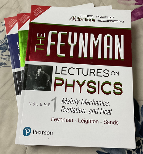 An image of a stack of the three "Feynman Lectures on Physics" books. Volume I is on top of the stack