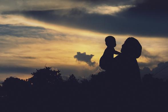 #Unsplash #image from the #Comilla #District #Bangladesh. A dramatic, atmospheric golden sunset fading with various forms of darker clouds drifting by. In the foreground at right is a dark silhouette of a woman wearing a cloth headscarf holding up a baby toward the center of the picture. She and the baby are both in complete shadow, as are treetops toward the left. Mood is one of maternal love, hope and promise in an world without certainties. 

Dated 2023 Jul 29, from Aifur Rahman. 
www.Unsplash.com/photos/a-silhouette-of-a-woman-holding-a-child-J6MaRSBIkI4

www.KronoMoon.org 🏳️‍🌈 ☮️ #KronoWatch