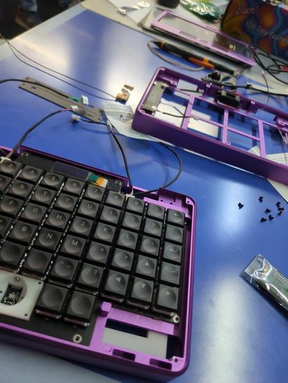 A purple pocket reform half assembled on a blue table