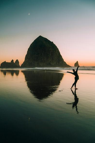 #Unsplash #image at #HaystackRock #CanonBeach #Oregon #US (h/t @JacquelineJannotta@me.dm). A lone female dancer strikes a dramatic pose out in very shallow water in her bare feet, as if greeting a tiny #Moon floating in the upper left of the picture. The center of the picture is dominated by a huge rock in silhouette, larger than a large building. Both the rock and dancer are reflected in the shimmering water. Other large jagged rocks are further out in the water. Lighting is twilight, with a rosy orange sunset fading from the horizon, and shades of pale blue above, welcoming evening to arrive.  

Dated 2019 Mar 30, from Josh Gordon.
www.Unsplash.com/photos/silhouette-photography-of-woman-in-beach-JgDmRxM2OOE 

www.KronoMoon.org  🏳️‍🌈 ☮️ 
#KronoWatch