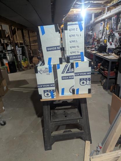 Foam board insulation braced and built into 4*16 open rectangles, to be turned into light boxes / golden ticket winners names.