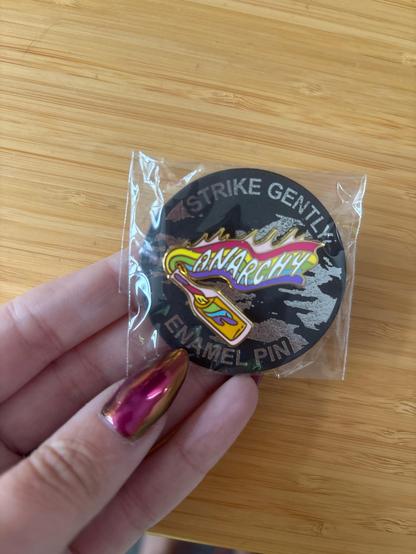 “Anarchy” Molotov cocktail pin but the rag is pride theme colored