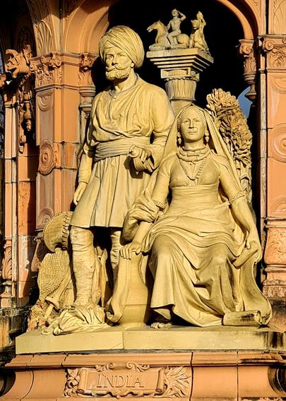 A Victorian-era representation of India, with a standing male figure in India military dress and a seated female figure in traditional dress.