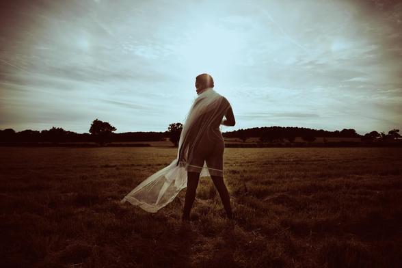 Editorial photograph of a model on an open field