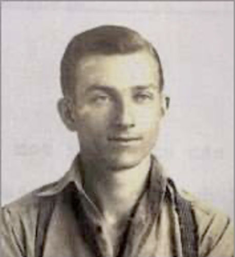 Photo of Edward Muscala. He is facing the camera and wearing suspenders and a loose fitting work shirt with open collar.