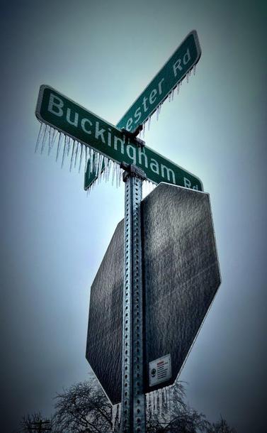 Ice street signs showing the corner of Buckingham and Manchester