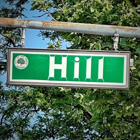 Weathered street sign for Hill street.