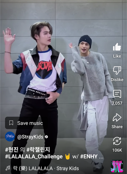 Ni-Ki of Enhyphen and Hyunjin of Stray Kids doing a dance challenge. Hyunjin has a grey scarf attached to his right(?) hip