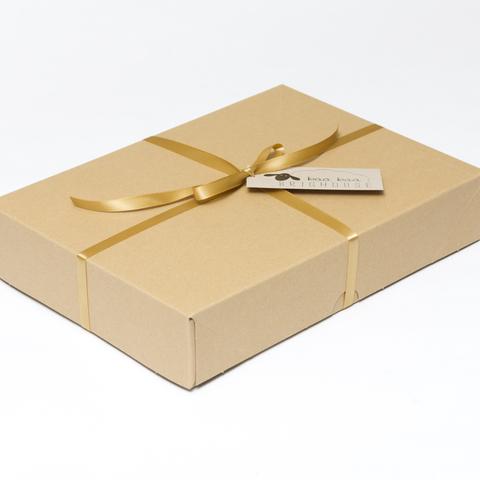 Picture shows a closed A4 box tied with gold ribbon.