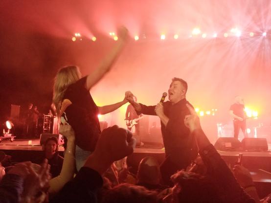 Ken Casey of the Dropkick Murphys sings a duet with a fan during Rose Tattoo