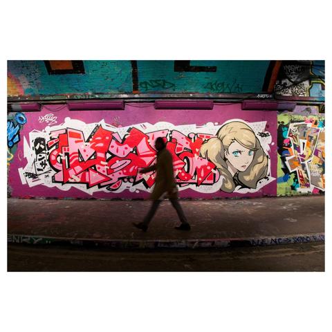 Coulor photo of street art in the Leake Street graffiti tunnel with a passerby strolling through the frame