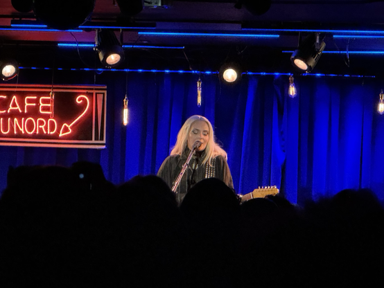 Eivør, a blonde white woman playing guitar and singing, onstage at the Cafe du Nord, Fen. 7, 2025.