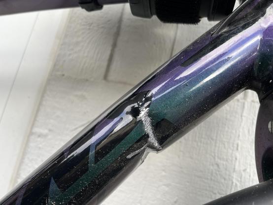 Close-up picture of down tube after collision with car, showing visible crack