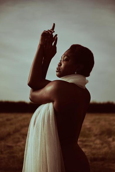 Editorial photograph of a model on an open field