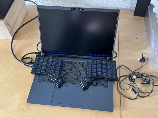 A split keyboard on top of a notebook keyboard.