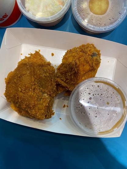 Close up photo of the 2 Spicy Jollichicken with its gravy, Mashed Potatoes, and Coleslaw.
