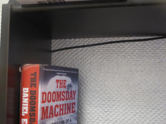 ethernet cable going behind a bookshelf and almost hugging a Doomsday machine