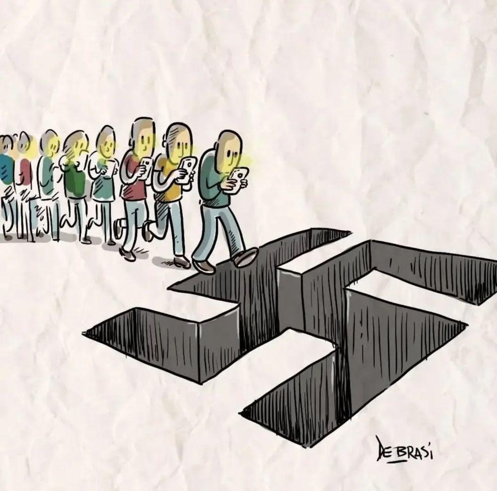 Cartoon: a line of people, immersed In their smartphones, walk toward a large, swastika shaped hole in the ground